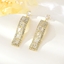 Show details for Trendy Gold Plated White Dangle Earrings with No-Risk Refund